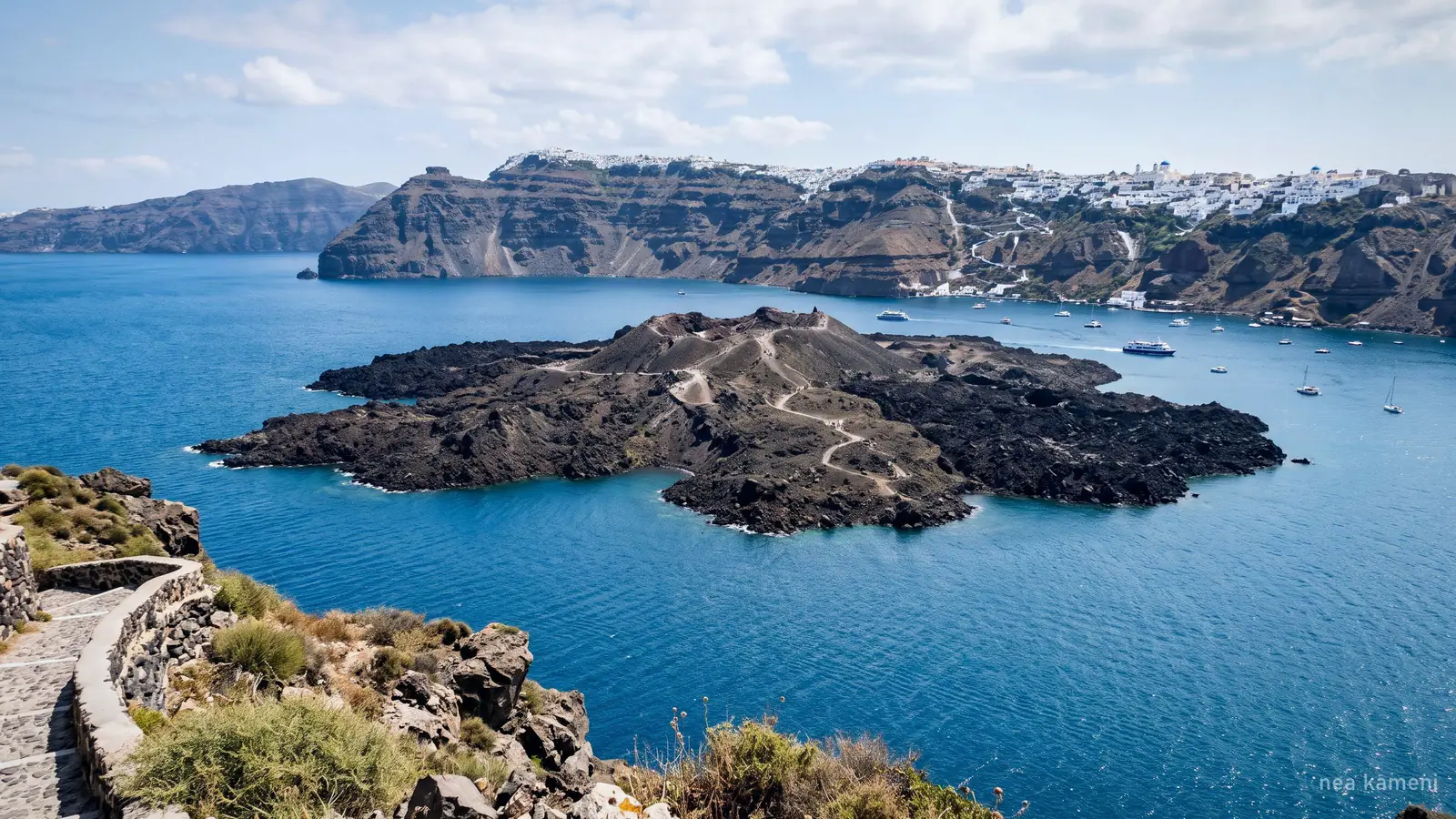 Nea Kameni, the dark volcanic island in the middle of the Santorini caldera, seen from the rim